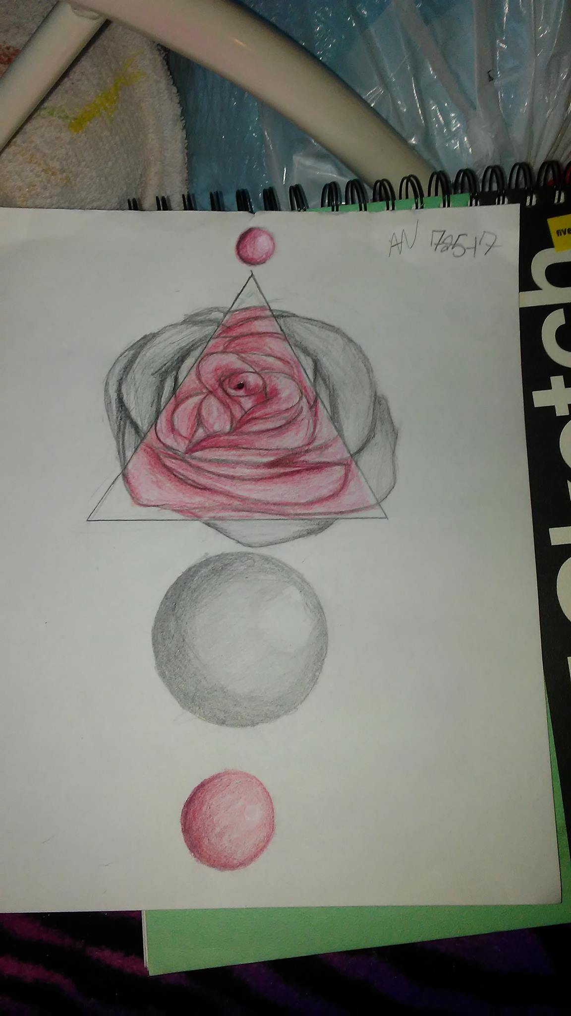 A drawing of a rose with spheres above and below it.